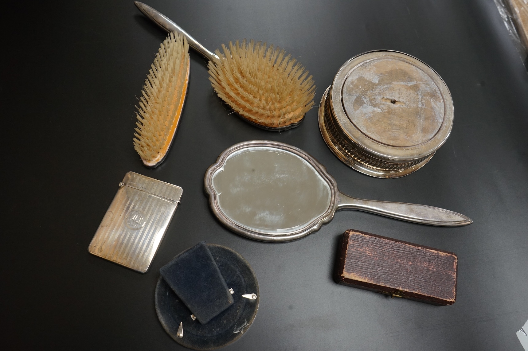 A George V silver rectangular card case by William Henry Sparrow, Birmingham, 1913, 89mm, a modern silver mounted circular photograph frame and five other items including a three piece silver plate and enamel mirror and